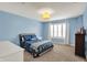 This bedroom features blue walls, a cozy bed, and a window with natural light for a calm atmosphere at 15023 Glenmoor Cir, Carmel, IN 46033