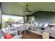 Inviting covered deck with dining and lounge areas, perfect for outdoor entertaining and relaxation at 15023 Glenmoor Cir, Carmel, IN 46033