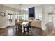 Dining area with a rustic wood table, views of the backyard, and seamless transition to the open-concept living room at 15023 Glenmoor Cir, Carmel, IN 46033