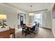 Elegant dining room with a rustic wood table and ample natural light at 15023 Glenmoor Cir, Carmel, IN 46033