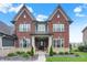 Charming two-story brick home with stone accents and manicured landscaping at 15023 Glenmoor Cir, Carmel, IN 46033
