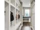Hallway mudroom area features custom built-in storage with bench seating, hooks, and white painted trim at 15023 Glenmoor Cir, Carmel, IN 46033
