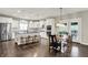 Modern kitchen featuring white cabinets, stainless steel appliances, a kitchen island and a breakfast nook at 15023 Glenmoor Cir, Carmel, IN 46033