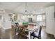 Bright kitchen featuring white cabinets, stainless steel appliances, and a rustic wood dining table at 15023 Glenmoor Cir, Carmel, IN 46033