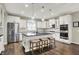 Modern kitchen featuring white cabinets, stainless steel appliances, a kitchen island with seating at 15023 Glenmoor Cir, Carmel, IN 46033