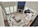 Open concept living room with soaring ceilings, stone fireplace, and large sectional sofa at 15023 Glenmoor Cir, Carmel, IN 46033