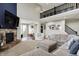 Spacious living room featuring a stone fireplace, soaring ceilings, and a view of the second-floor landing at 15023 Glenmoor Cir, Carmel, IN 46033