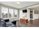 Inviting living room features a comfortable leather couch and large windows at 15023 Glenmoor Cir, Carmel, IN 46033