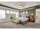 Spacious main bedroom features a tray ceiling, carpet, and a sitting area with lots of natural light at 15023 Glenmoor Cir, Carmel, IN 46033
