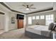 Main bedroom offers a ceiling fan, carpet, and large windows, plus access to an ensuite bathroom at 15023 Glenmoor Cir, Carmel, IN 46033