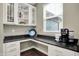 Office area with white cabinets, desk space, granite counters, shelves, and a window with natural light at 15023 Glenmoor Cir, Carmel, IN 46033