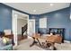 Bright office space features classic blue walls, a large desk, and natural lighting at 15023 Glenmoor Cir, Carmel, IN 46033