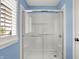 A bright bathroom with a clear glass-enclosed shower for a clean and modern design at 15023 Glenmoor Cir, Carmel, IN 46033