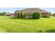 Manicured backyard with healthy green grass, mature trees, and a red brick home exterior at 1607 Michelle Manor, Danville, IN 46122