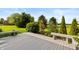 Spacious backyard with a wooden deck and bench seating overlooking mature trees and manicured landscaping at 1607 Michelle Manor, Danville, IN 46122