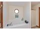 Bright bathroom features a soaking tub with tile surround and a unique octagon window providing natural light at 1607 Michelle Manor, Danville, IN 46122
