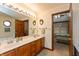 Main bathroom featuring double sinks, wood cabinetry, and soaking tub at 1607 Michelle Manor, Danville, IN 46122