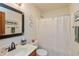 Well-lit bathroom with a sink vanity, framed mirror, toilet, and a shower with a neutral shower curtain at 1607 Michelle Manor, Danville, IN 46122