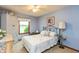 Comfortable bedroom with light blue walls, a ceiling fan, and a bed with decorative pillows at 1607 Michelle Manor, Danville, IN 46122