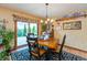 Dining room with hardwood floors, slider to deck, and chandelier lighting at 1607 Michelle Manor, Danville, IN 46122