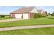 Spacious brick home with a two-car garage and manicured lawn at 1607 Michelle Manor, Danville, IN 46122