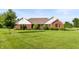 Charming brick home with a well-manicured lawn and mature trees, perfect curb appeal at 1607 Michelle Manor, Danville, IN 46122
