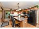 Cozy kitchen with an island, oak cabinets, and adjacent dining area at 1607 Michelle Manor, Danville, IN 46122