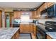 Well-lit kitchen featuring oak cabinets, subway tile backsplash, and stainless steel appliances at 1607 Michelle Manor, Danville, IN 46122