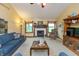 Cozy living room with fireplace, plush blue seating, and neutral carpet is an inviting space at 1607 Michelle Manor, Danville, IN 46122
