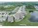 Aerial view of a suburban neighborhood with tree-lined streets, well-manicured lawns, and a pond at 1661 Devonshire Ave, Avon, IN 46123