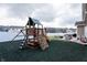Home's backyard includes a playset, concrete patio and fenced lawn at 1661 Devonshire Ave, Avon, IN 46123
