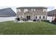 Home's backyard features a patio with seating and a grill, plus a grassy area at 1661 Devonshire Ave, Avon, IN 46123