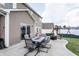 Outdoor patio dining area with view of the backyard and wooden play set at 1661 Devonshire Ave, Avon, IN 46123