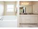 A luxurious bathroom features a soaking tub and dual vanity sinks at 1661 Devonshire Ave, Avon, IN 46123