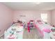 Bright bedroom featuring twin beds, pink walls, and charming decor creating a playful atmosphere at 1661 Devonshire Ave, Avon, IN 46123