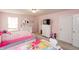 Bright bedroom featuring twin beds, pink walls, and charming decor at 1661 Devonshire Ave, Avon, IN 46123