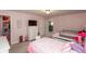 Bright bedroom featuring twin beds, pink walls, and an ensuite bathroom at 1661 Devonshire Ave, Avon, IN 46123