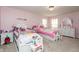Pink bedroom with two beds, white furniture, neutral carpet, and natural light at 1661 Devonshire Ave, Avon, IN 46123
