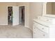This beige bedroom boasts white trim, a closet view, a matching dresser with a mirror, and plush carpet at 1661 Devonshire Ave, Avon, IN 46123