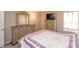 Spacious bedroom with dresser, lamps, and a mounted TV at 1661 Devonshire Ave, Avon, IN 46123