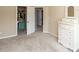 This beige bedroom boasts white trim, a closet view, a matching dresser with a mirror, and plush carpet at 1661 Devonshire Ave, Avon, IN 46123