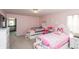 Bright bedroom featuring twin beds, pink walls, and charming decor at 1661 Devonshire Ave, Avon, IN 46123