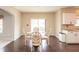 Cozy dining area with a glass-top table, decorative chairs, and hardwood floors at 1661 Devonshire Ave, Avon, IN 46123