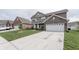 Charming two-story home with brown siding, brick accents, white trim, and an attached two-car garage at 1661 Devonshire Ave, Avon, IN 46123