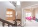 View of the foyer from the stairs, showcases open layout with a playroom and the front door at 1661 Devonshire Ave, Avon, IN 46123