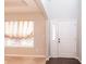 Bright foyer featuring a window with curtains and a white front door with sidelights at 1661 Devonshire Ave, Avon, IN 46123