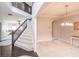 Bright foyer with staircase leading to the second floor, and an open view to the dining room at 1661 Devonshire Ave, Avon, IN 46123