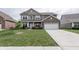 Charming two-story home with lush green lawn and attached garage at 1661 Devonshire Ave, Avon, IN 46123