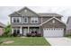 Traditional two-story home with brick accents, well-manicured lawn and landscaping at 1661 Devonshire Ave, Avon, IN 46123
