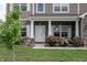 Inviting front porch with flower boxes, updated siding, and lovely landscaping at 1661 Devonshire Ave, Avon, IN 46123